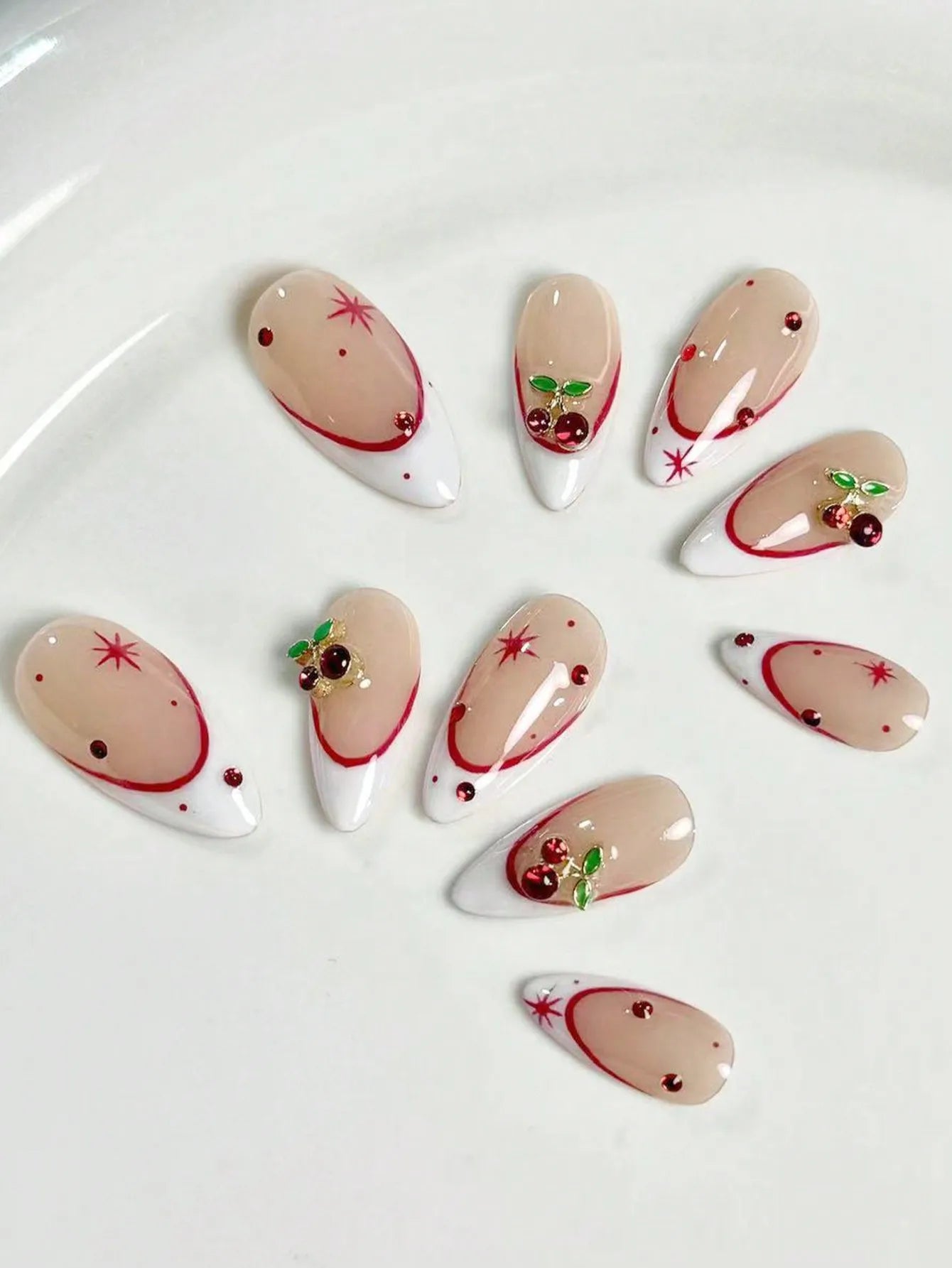 10 pieces of pure handmade almond-shaped nails, with white French tips and red cherry decorations.