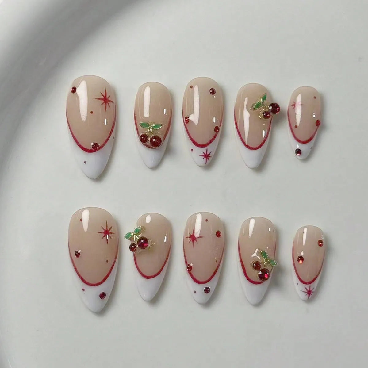10 pieces of pure handmade almond-shaped nails, with white French tips and red cherry decorations.